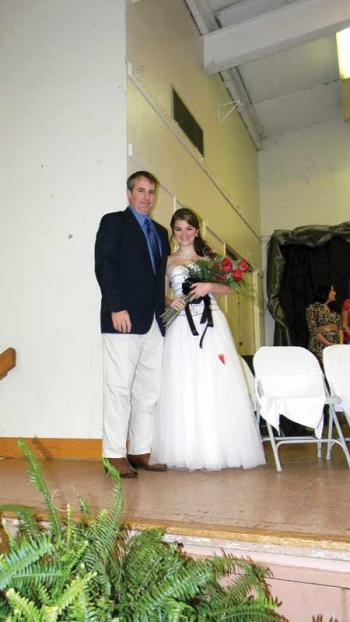 Tournoi rider Chuck Manuel presents roses to newly-crowned Teen Tournoi Queen Ciera Morein.