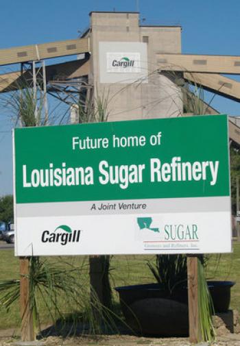 Sweet Deal — Lonnie Champagne (center) general manager of Louisiana Sugar Cane Products Inc. in Breaux Bridge, totes his oversized sugar spoon after he and others turned the first bit of soil at the Louisiana Sugar Refining LLC ground-breaking ceremony. St. John the Baptist Parish President Bill Hubbard (left) and District 57 State Rep. Nickie Monica also participated.