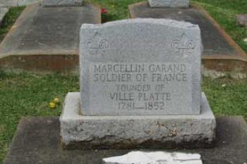 The headstone on Marcellin Garand's grave, which is to the right, shortly after entering the driveway into the center of Ville Platte's original cemetery, from East Cotton Street. The grave site will be one of the stops on the "video caravan" that will pass through Ville Platte on Sunday.